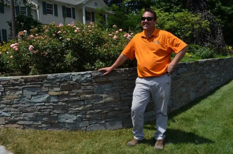 Mike Tode in Front of Stone Retaining Wall - The Tode Show